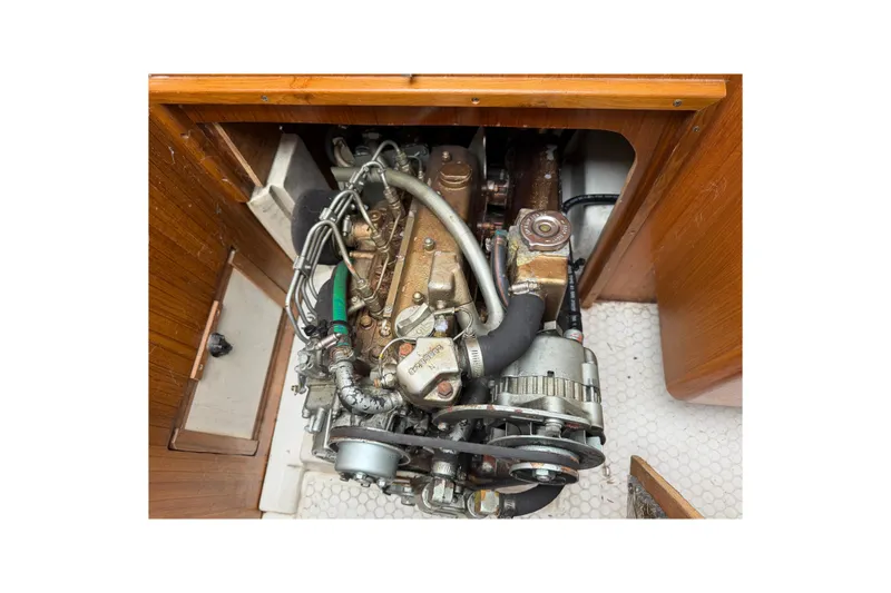 Slide: The Image of Engine compartment of a 1999 Catalina 36 MkII sailboat, showcasing mechanical components. - 20