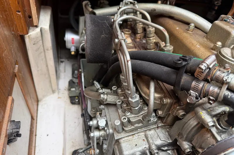 Slide: The Image of Engine compartment of a 1999 Catalina 36 MkII sailboat, showcasing mechanical components. - 21