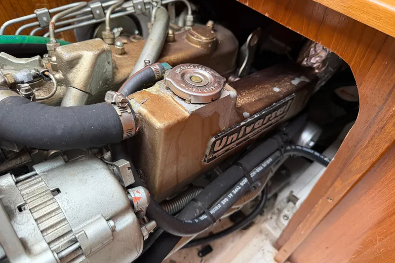 Slide: The Image of Engine compartment of a 1999 Catalina 36 MkII sailboat, featuring a Universal diesel engine. - 22