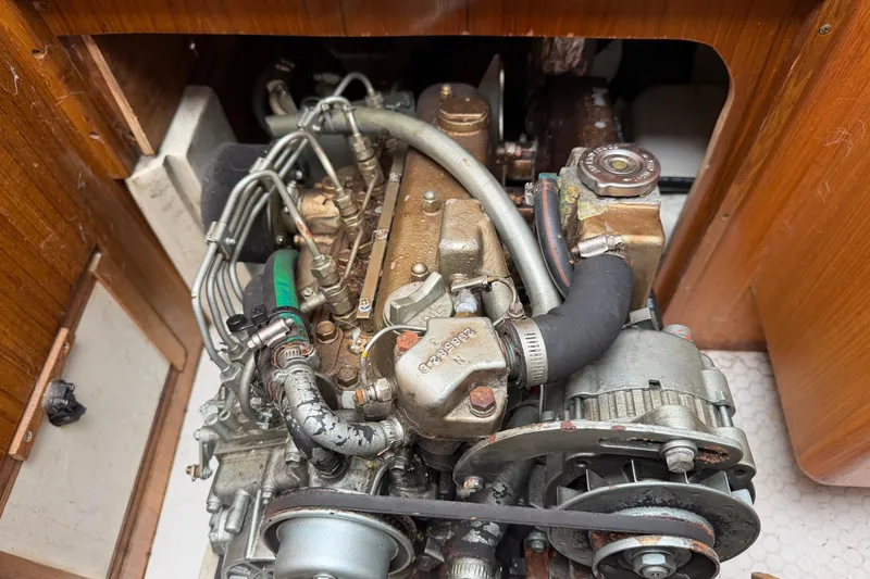 Slide: The Image of Engine compartment of a 1999 Catalina 36 MkII sailboat, showcasing mechanical components. - 24