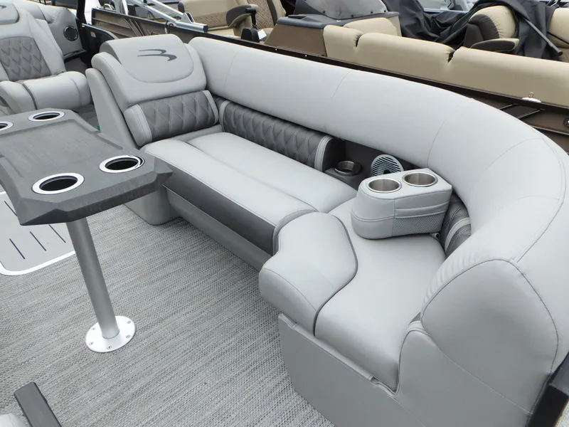 Slide: The Image of 2023 Bennington 24 LXSFBA boat interior with gray seating and table. - 4