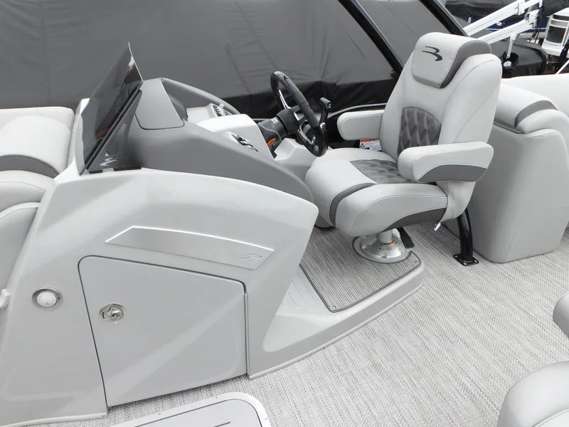 Slide: The Image of 2023 Bennington 24 LXSFBA boat interior with captain's chair and helm station. - 7