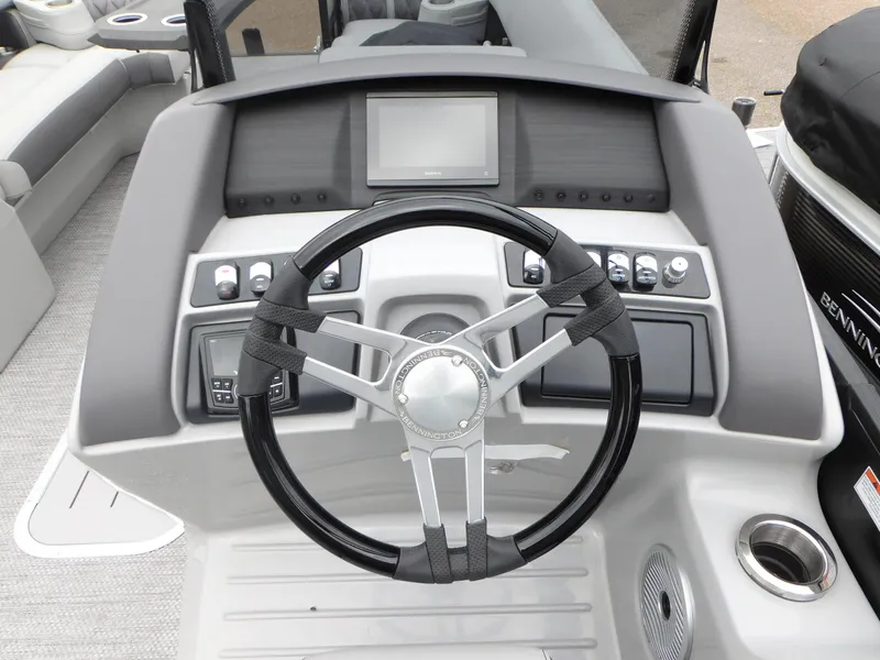 Slide: The Image of 2023 Bennington 24 LXSFBA boat dashboard with steering wheel and control panel. - 8
