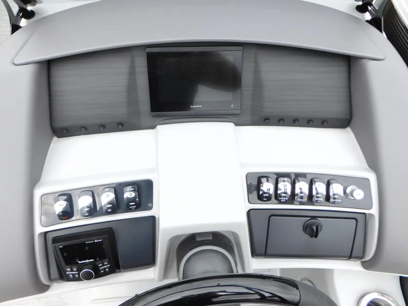 Slide: The Image of 2023 Bennington 24 LXSFBA boat dashboard with control panel and display screen. - 9