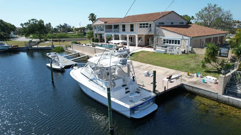 Slide: The Image of 2003 Ocean 40 Super Sport yacht docked by waterfront home. - 10