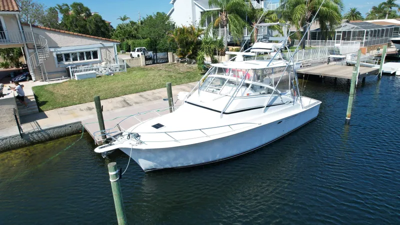 Slide: The Image of 2003 Ocean 40 Super Sport yacht docked near waterfront homes. - 11