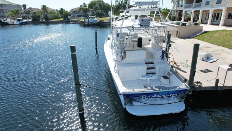 Slide: The Image of 2003 Ocean 40 Super Sport yacht docked in a sunny marina. - 14