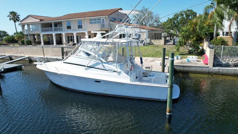 Slide: The Image of 2003 Ocean 40 Super Sport yacht docked near waterfront homes. - 15
