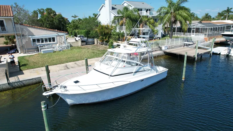 Slide: The Image of 2003 Ocean 40 Super Sport yacht docked near waterfront homes. - 18