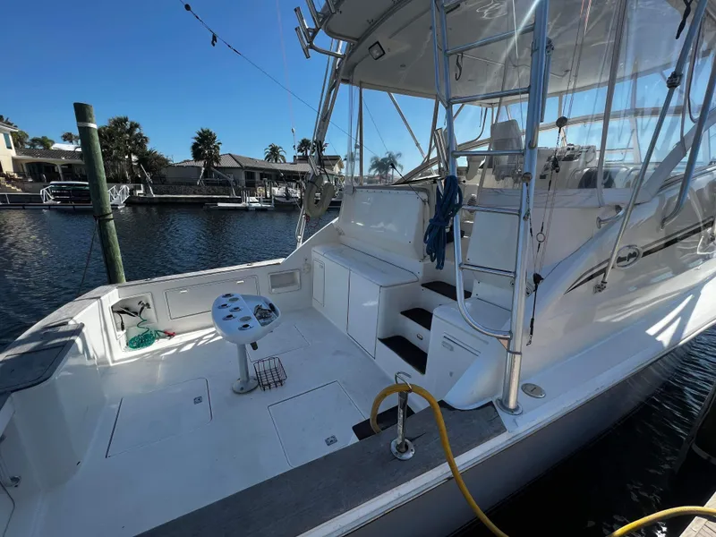 Slide: The Image of 2003 Ocean 40 Super Sport yacht docked, featuring spacious deck and fishing equipment. - 23