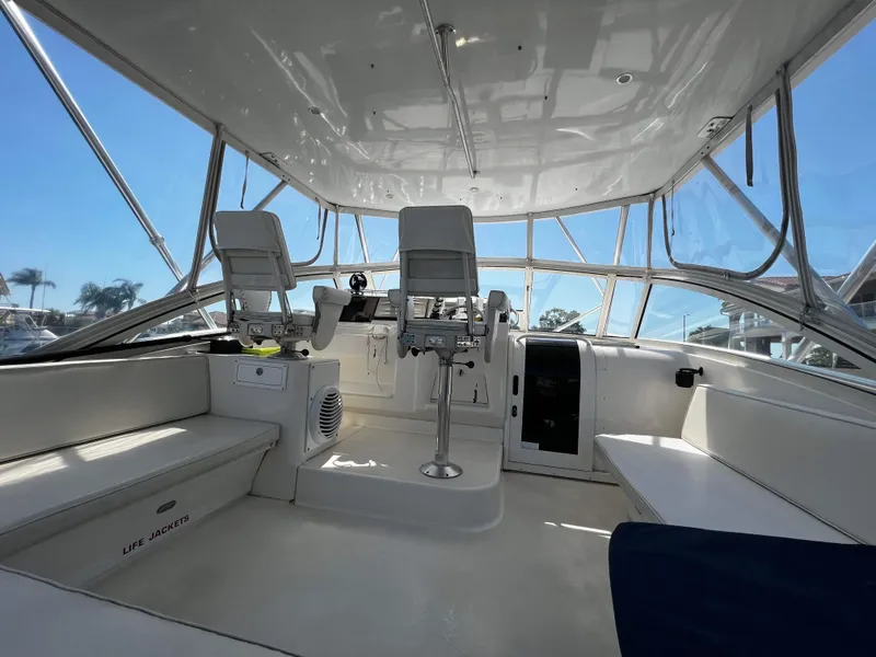 Slide: The Image of 2003 Ocean 40 Super Sport boat interior with helm, seating, and clear canopy. - 25