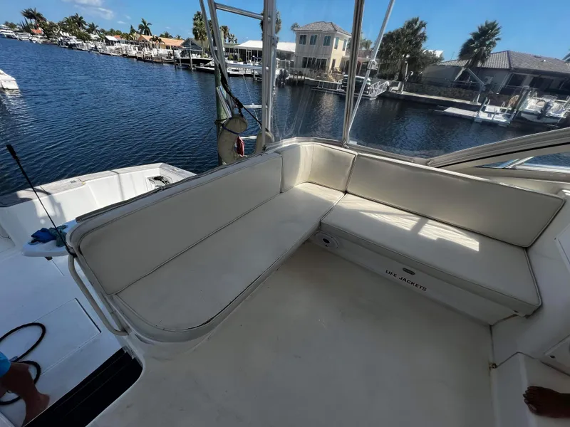 Slide: The Image of 2003 Ocean 40 Super Sport boat interior with seating, docked by waterfront homes. - 43