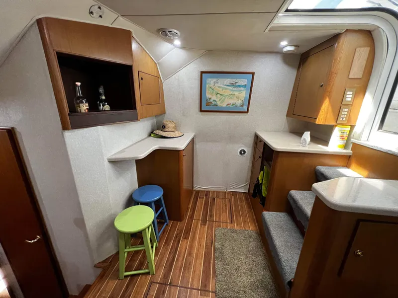 Slide: The Image of Interior of 2003 Ocean 40 Super Sport yacht with wooden flooring and bar stools. - 48