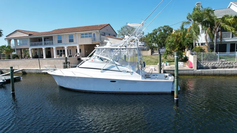 Slide: The Image of 2003 Ocean 40 Super Sport yacht docked near waterfront homes. - 6