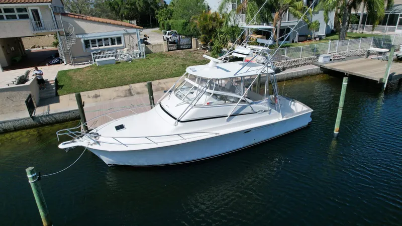 Slide: The Image of 2003 Ocean 40 Super Sport yacht docked near waterfront home. - 8