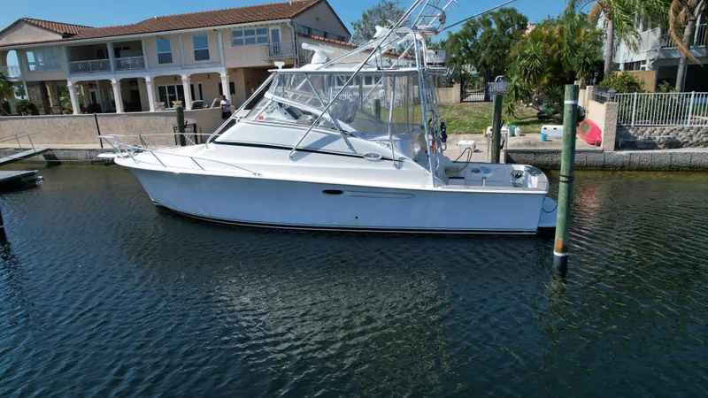Slide: The Image of 2003 Ocean 40 Super Sport yacht docked near waterfront homes. - 9