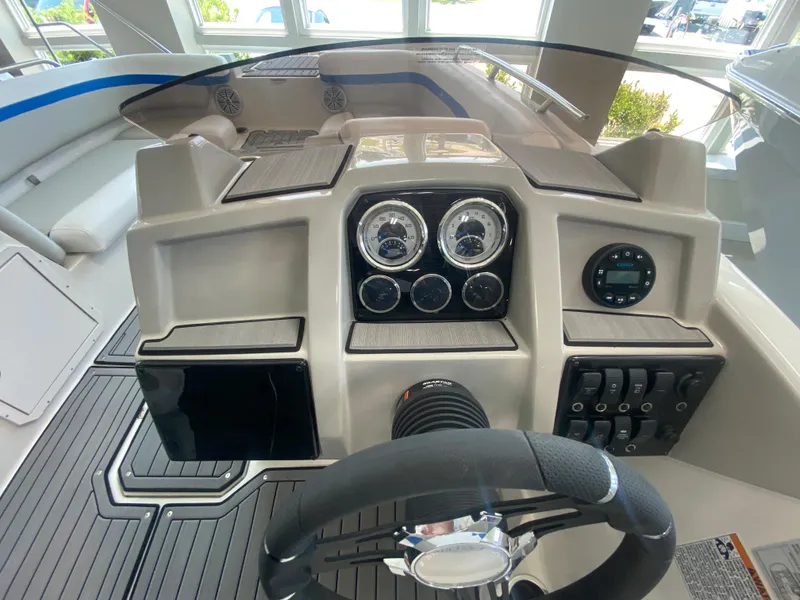 Slide: The Image of 2024 Starcraft SVX 211 boat dashboard with steering wheel and control panel. - 13