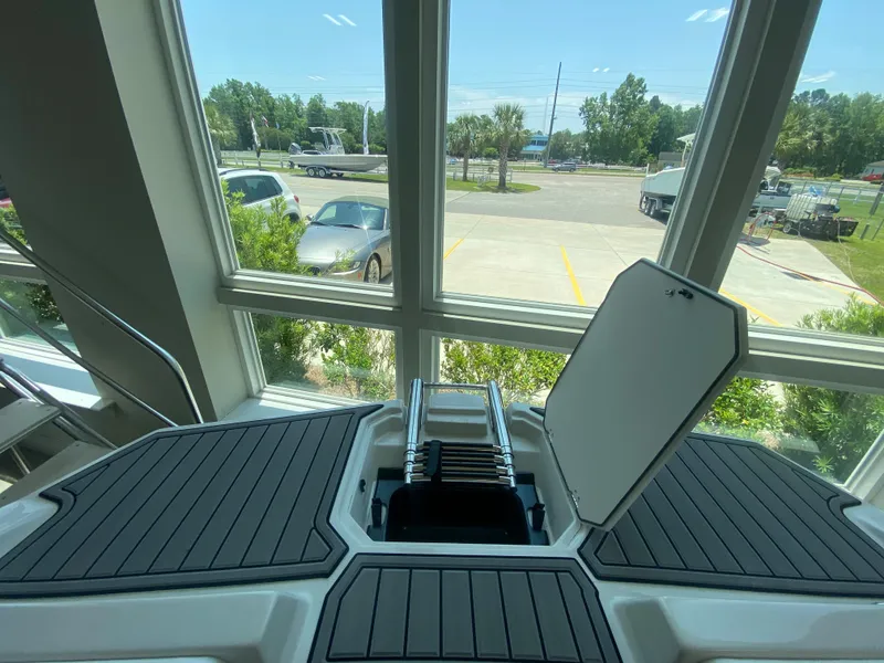 Slide: The Image of 2024 Starcraft SVX 211 boat with open hatch and ladder, displayed indoors. - 17