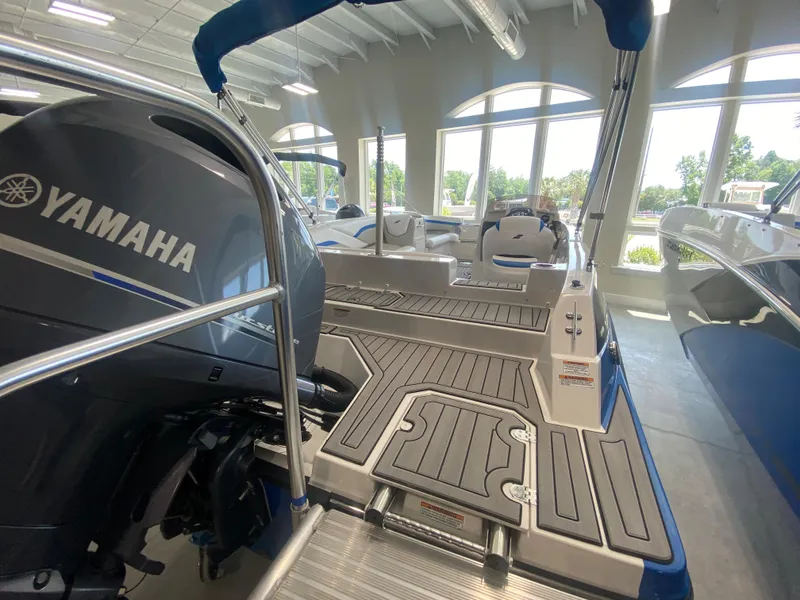Slide: The Image of 2024 Starcraft SVX 211 boat with Yamaha outboard motor in showroom. - 2