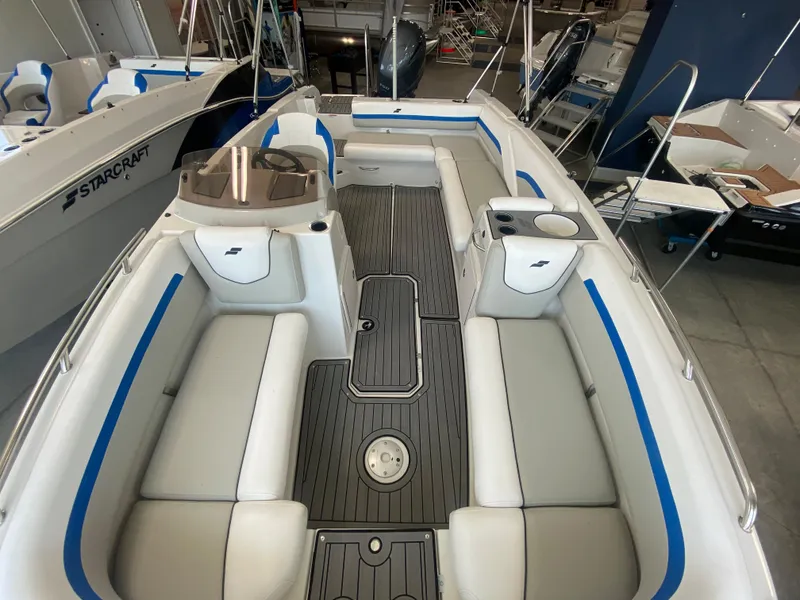 Slide: The Image of 2024 Starcraft SVX 211 boat interior with white and blue seating. - 5