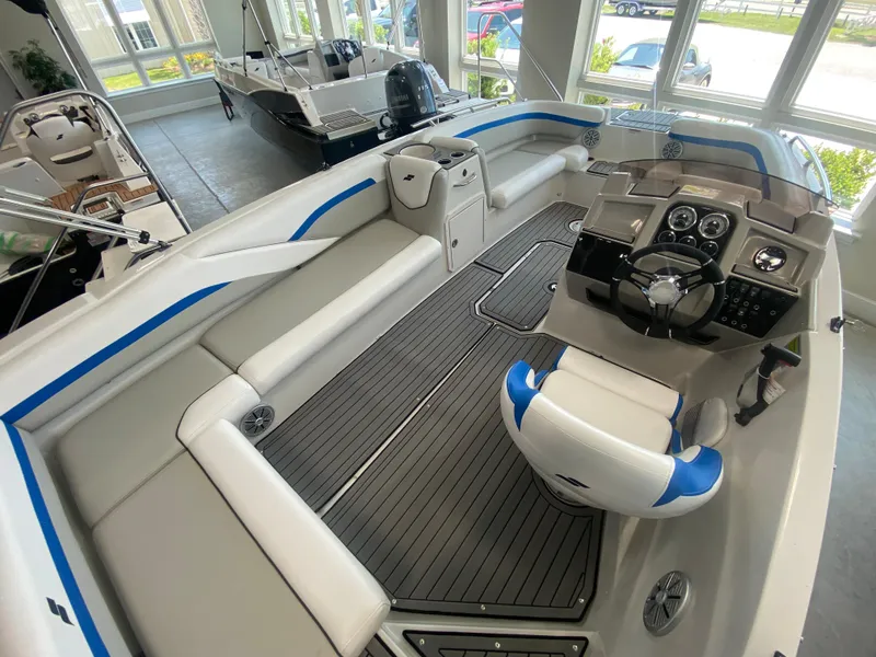 Slide: The Image of 2024 Starcraft SVX 211 boat interior with seating and control console. - 6