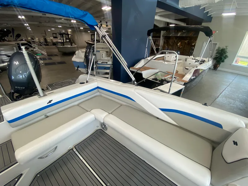 Slide: The Image of 2024 Starcraft SVX 211 boat interior with seating and outboard motor in showroom. - 7