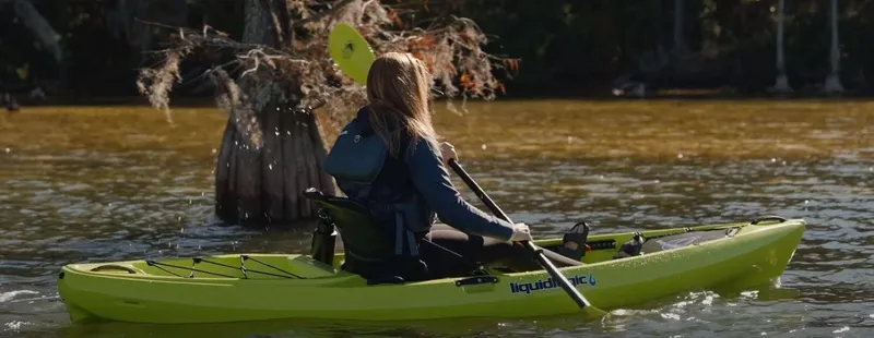 Slide: The Image of Person kayaking on a Liquidlogic Kiawah 10.5 in a serene lake, 2023 model. - 7