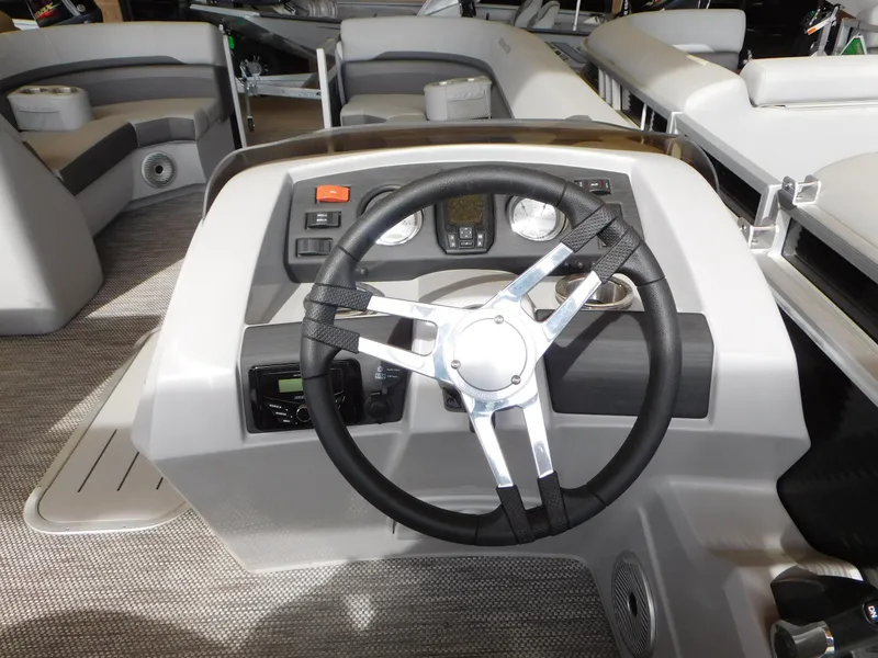 Slide: The Image of 2023 Bennington 22 SXL boat steering console with modern controls and sleek design. - 4