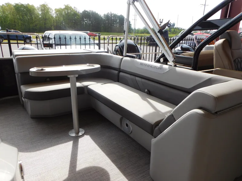 Slide: The Image of 2023 Bennington 22 SXL pontoon boat interior with seating and table. - 5