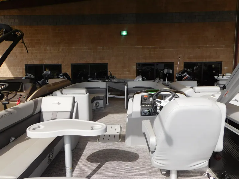 Slide: The Image of 2023 Bennington 22 SXL pontoon boat interior with modern seating and steering console. - 6