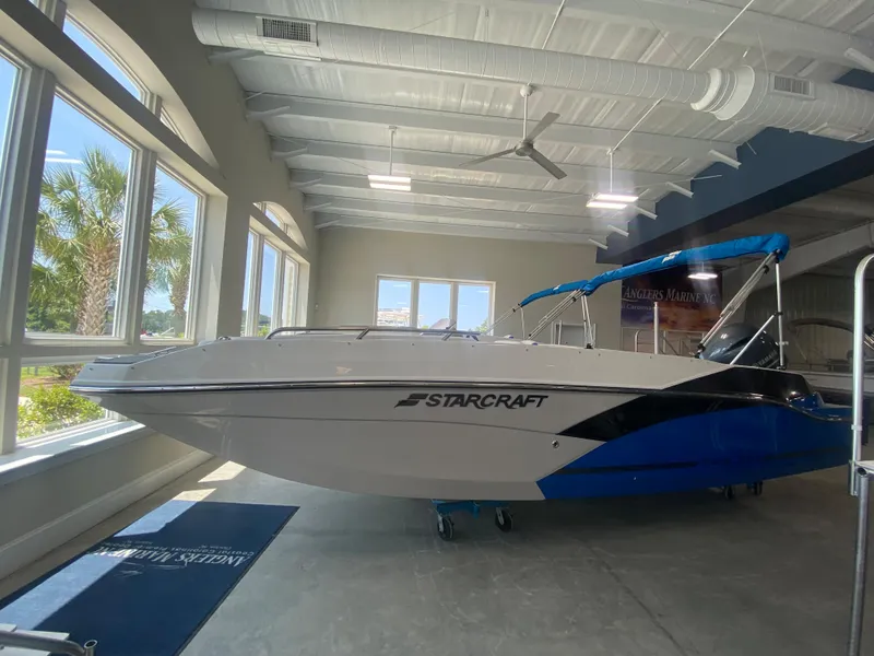 The Image of 2024 Starcraft SVX 211 boat displayed indoors with blue accents. - 0