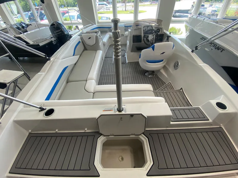 Slide: The Image of 2024 Starcraft SVX 211 boat interior with seating and steering console. - 4