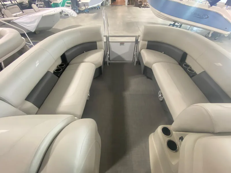 Slide: The Image of 2023 Starcraft LX22 R pontoon boat interior with spacious seating and cup holders. - 5