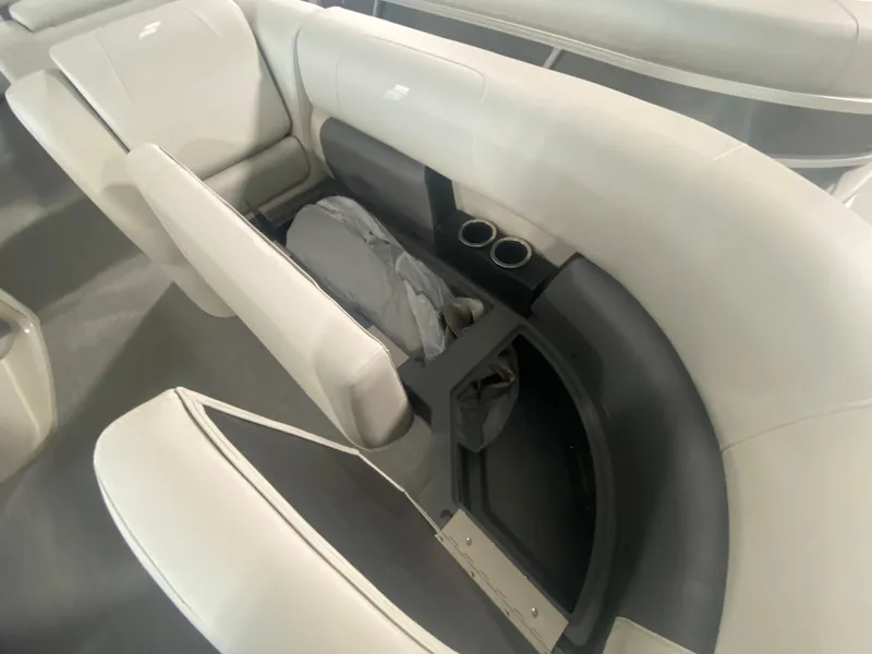 Slide: The Image of 2023 Starcraft LX22 R boat interior with storage compartment and cup holders. - 6