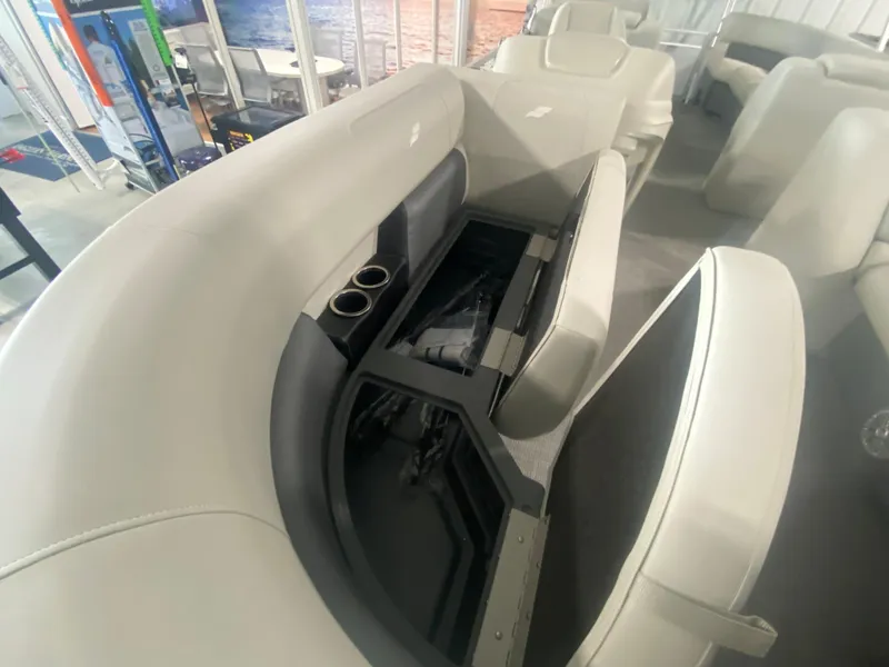 Slide: The Image of 2023 Starcraft LX22 R boat interior with storage compartment and cup holders. - 7