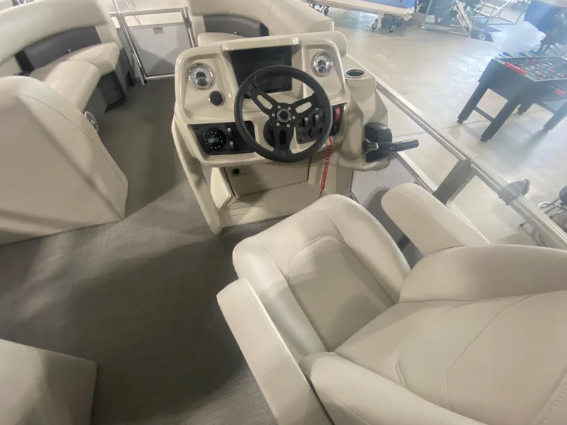 Slide: The Image of 2023 Starcraft LX22 R boat interior with steering console and seating. - 8