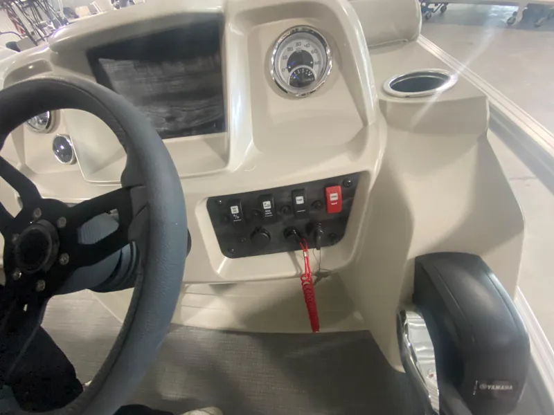 Slide: The Image of 2023 Starcraft LX22 R boat dashboard with steering wheel and control panel. - 10