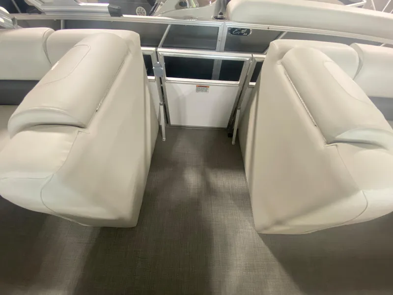 Slide: The Image of 2023 Starcraft LX22 R boat interior with beige seating and gray flooring. - 2