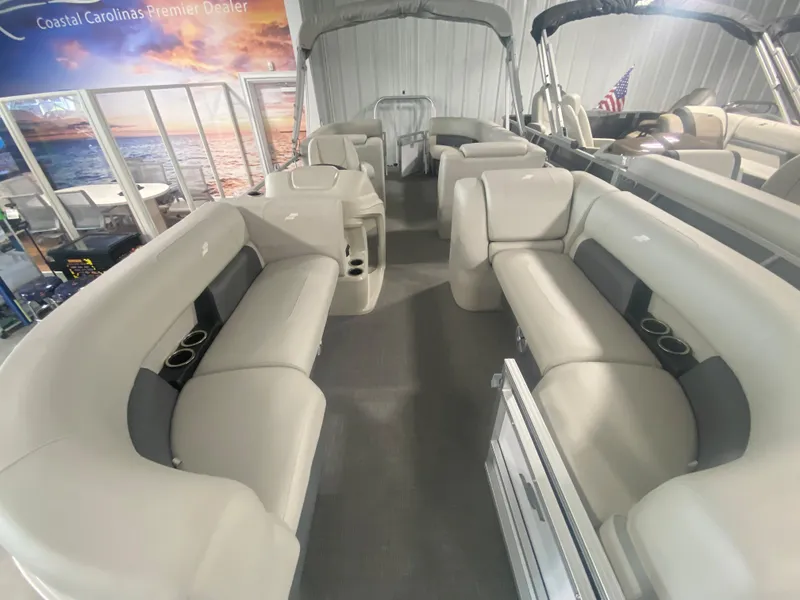 Slide: The Image of 2023 Starcraft LX22 R pontoon boat interior with spacious seating and cup holders. - 3