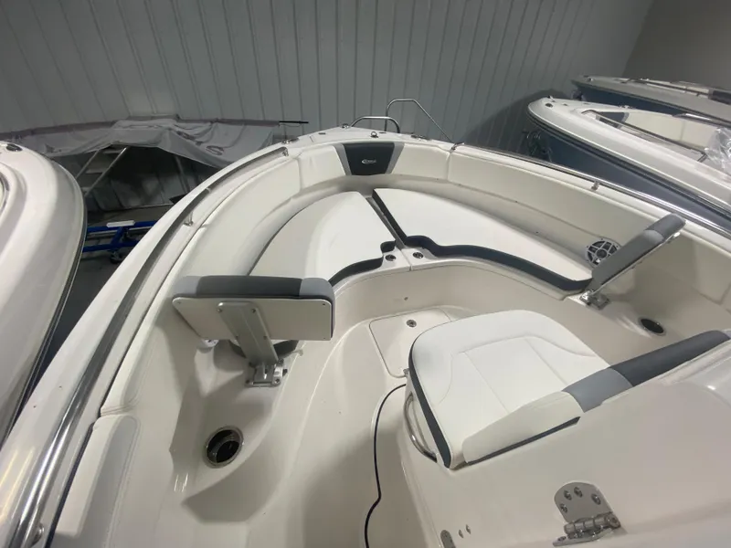 Slide: The Image of 2024 Robalo R222 boat interior with white and gray seating in a showroom. - 11