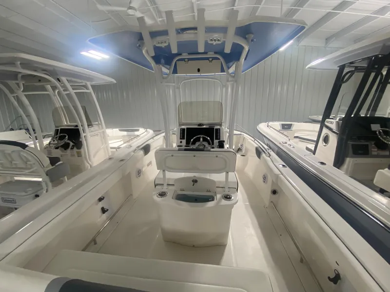 Slide: The Image of 2024 Robalo R222 center console boat in showroom. - 2