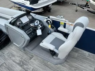 Slide: The Image of 2023 Godfrey Monaco 235C Back Porch boat cockpit with steering wheel and captain's chair. - 7