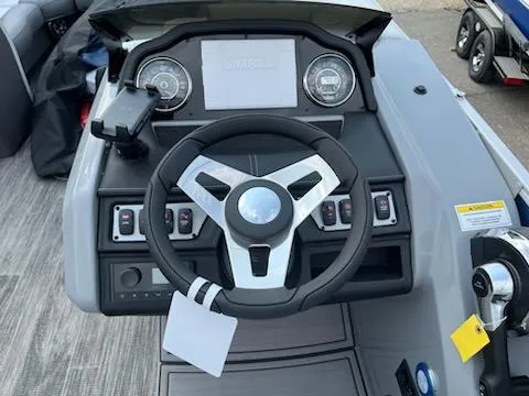 Slide: The Image of 2023 Godfrey Monaco 235C Back Porch boat dashboard with steering wheel and controls. - 8