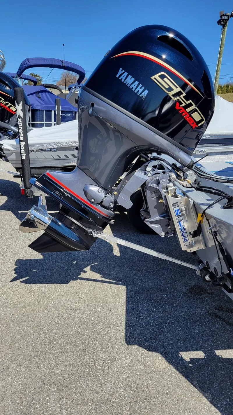 Slide: The Image of 2025 Xpress H17C boat with Yamaha Vmax 90 engine, parked outdoors. - 12