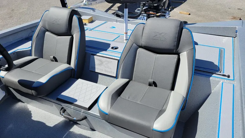 Slide: The Image of 2025 Xpress H17C boat interior with dual gray seats and blue accents. - 16