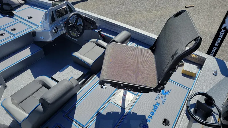 Slide: The Image of 2025 Xpress H17C Crappie boat interior with seating and steering console. - 9
