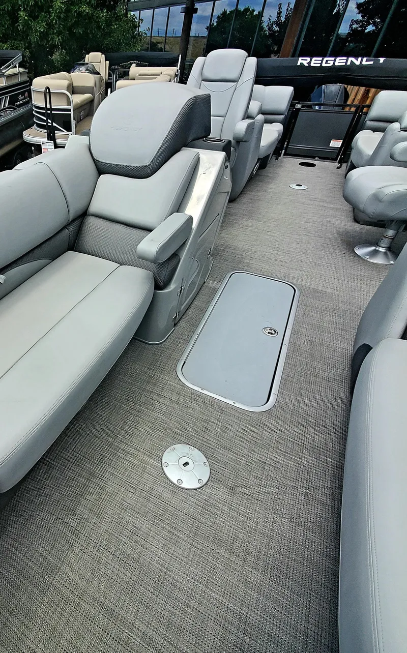 Slide: The Image of 2023 Regency 230 DL3 pontoon boat interior with luxurious seating. - 2