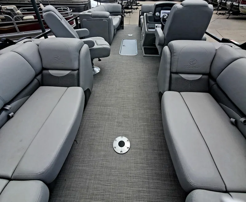Slide: The Image of 2023 Regency 230 DL3 pontoon boat interior with gray seating and carpet. - 4