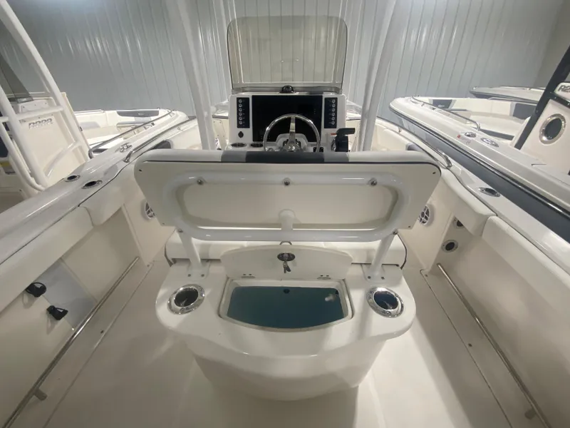 Slide: The Image of 2024 Robalo R222 boat interior with open storage compartment and helm station. - 6