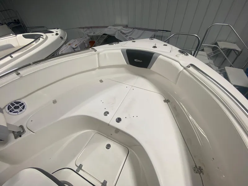 Slide: The Image of 2024 Robalo R222 boat interior, spacious white deck with storage compartments. - 14
